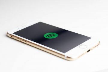 gold iPhone 7 displaying spotify logo